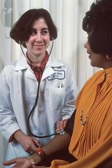 Nurse examining a patient during a clinical visit