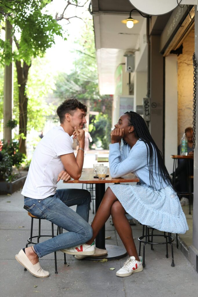Two adults talking at an outdoor cafe