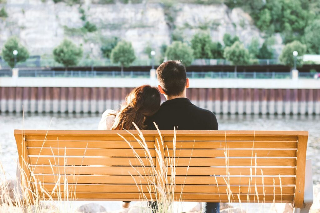 Couple sitting together on a park bench