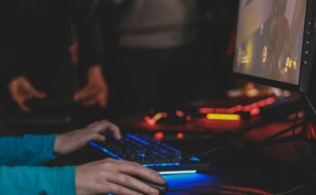 Hands using gaming controls in a dim room