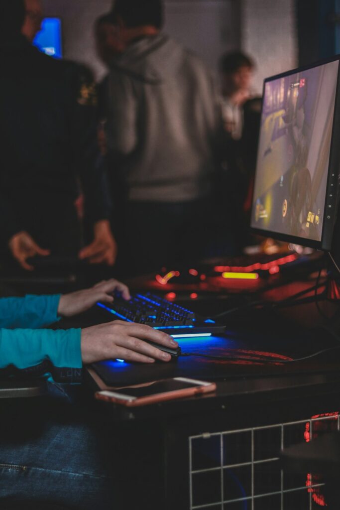 Hands using gaming controls in a dim room
