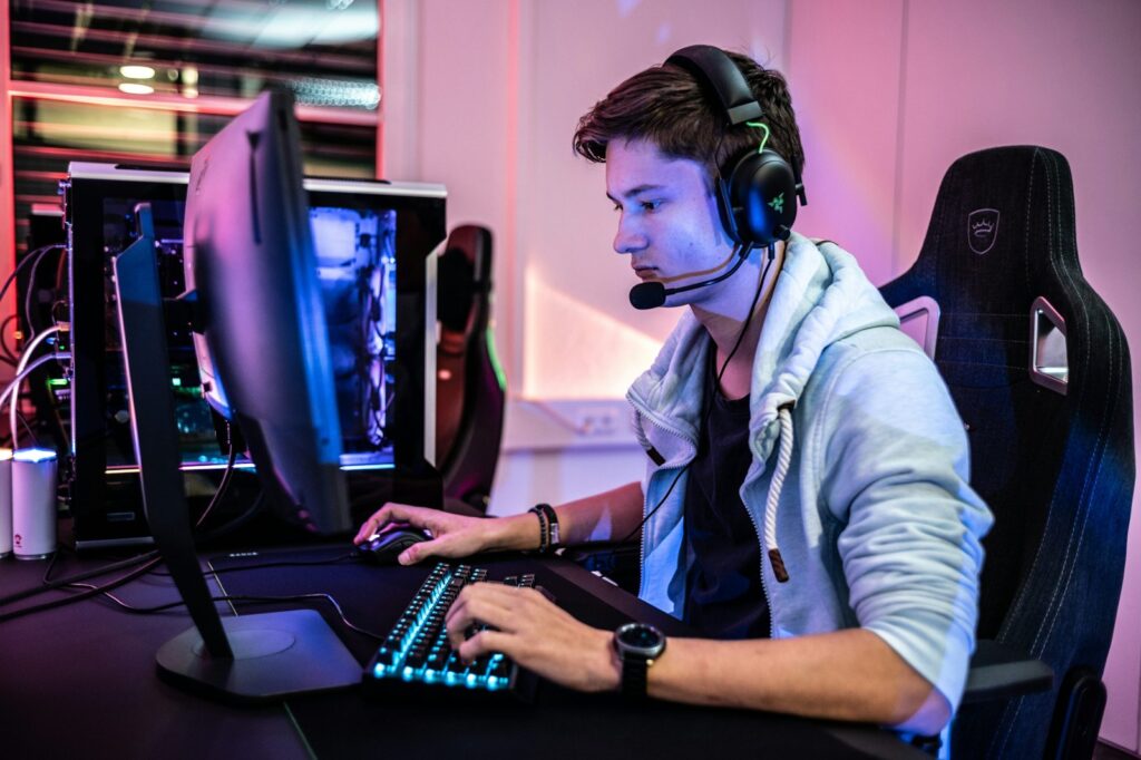 Gamer seated at a colorful computer setup