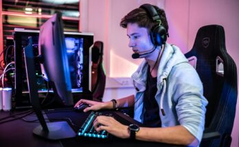 Gamer seated at a colorful computer setup
