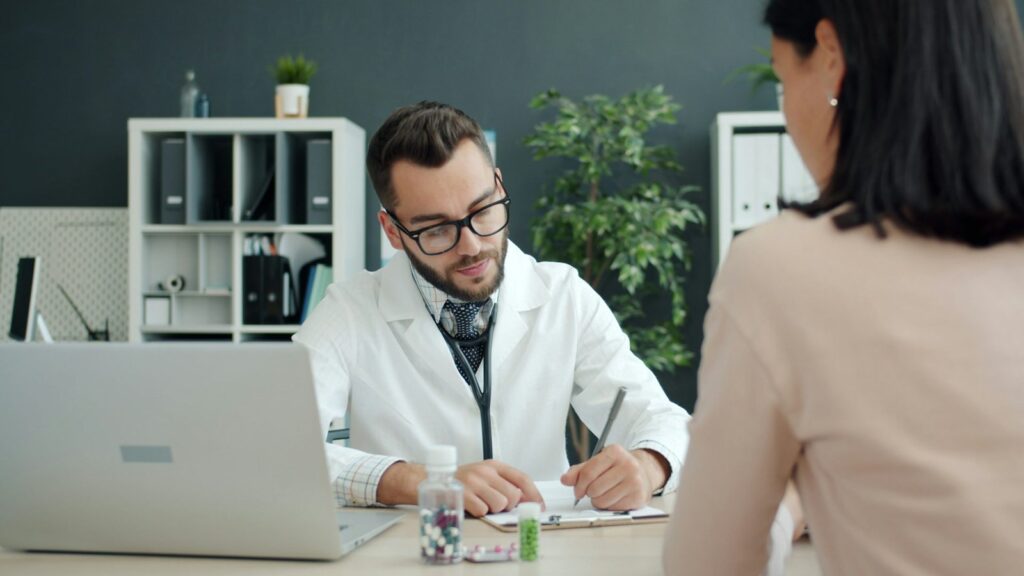 Doctor consulting with a patient at a desk