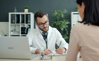 Doctor consulting with a patient at a desk