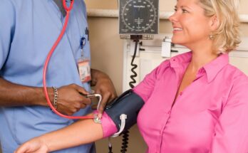 Healthcare worker measuring a patient’s blood pressure