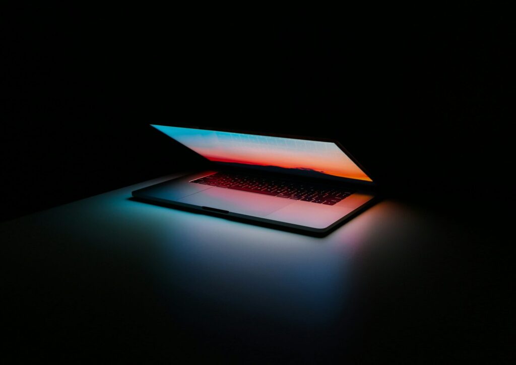 Open laptops against a dark background