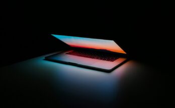 Open laptops against a dark background