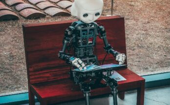Small robot model beside a wooden case