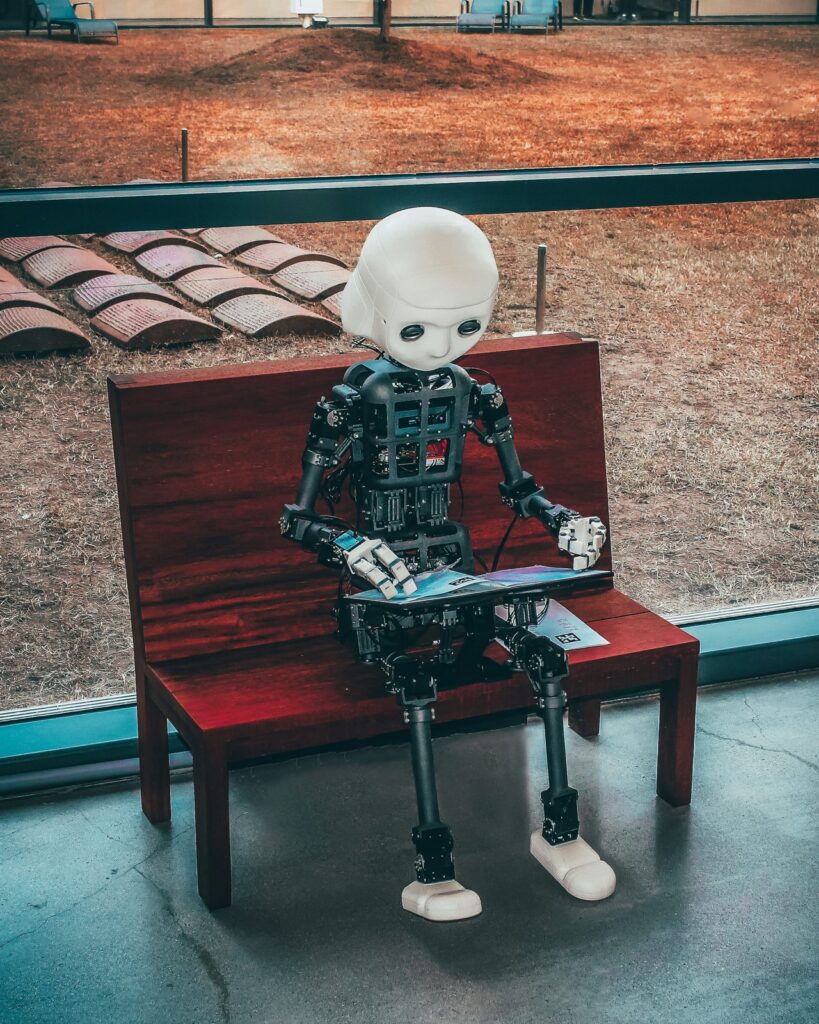 Small robot model beside a wooden case