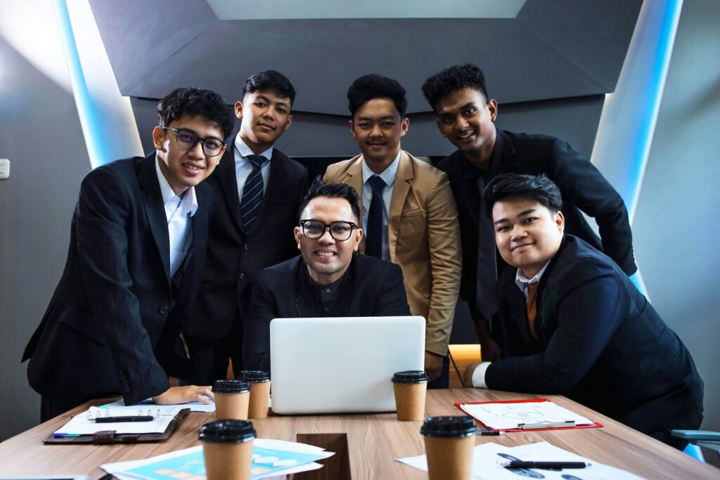 Business team gathered around a laptop