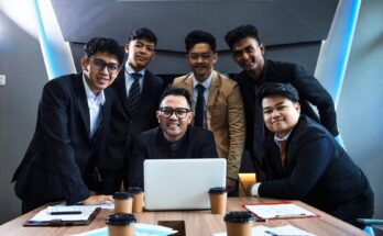 Business team gathered around a laptop