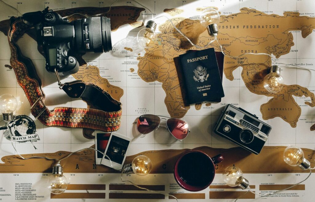 Travel cameras and passport arranged on a map