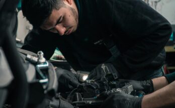Mechanic inspecting a vehicle engine