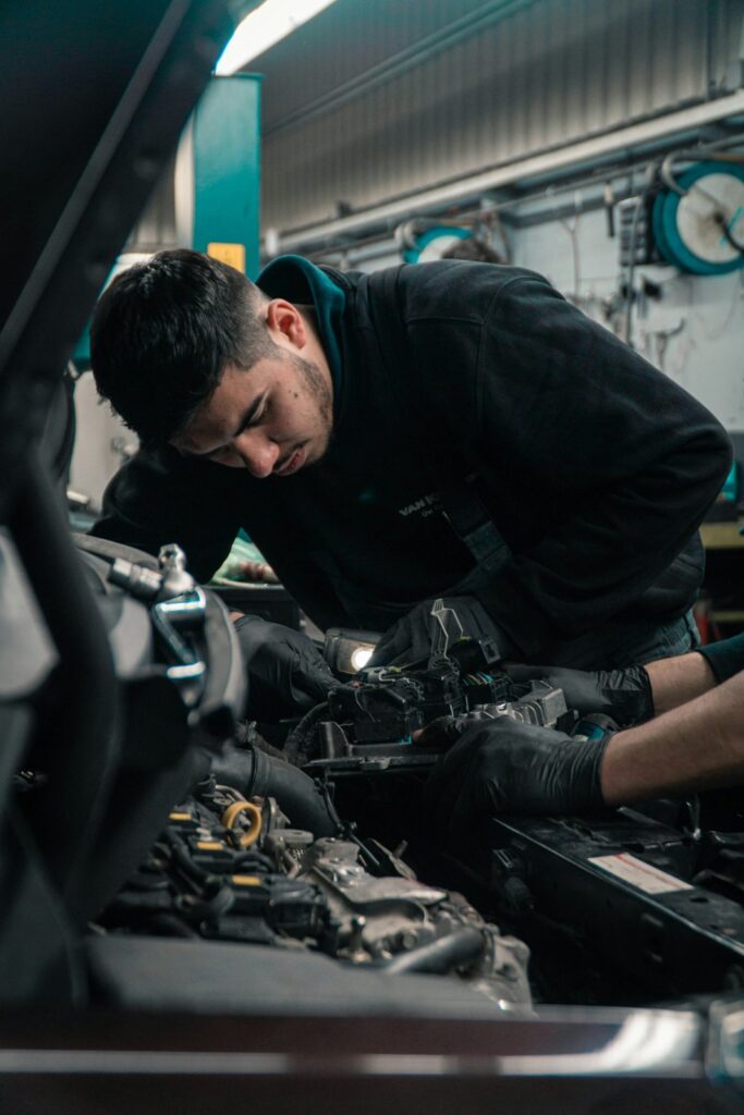 Mechanic inspecting a vehicle engine