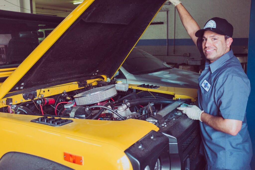 Technician checking a car engine