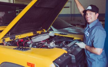 Technician checking a car engine